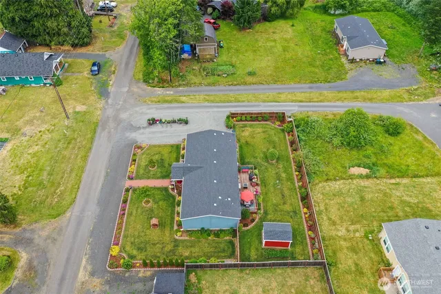 an aerial view of a house with a garden and swimming pool