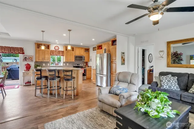 a living room with furniture dining area and a chandelier
