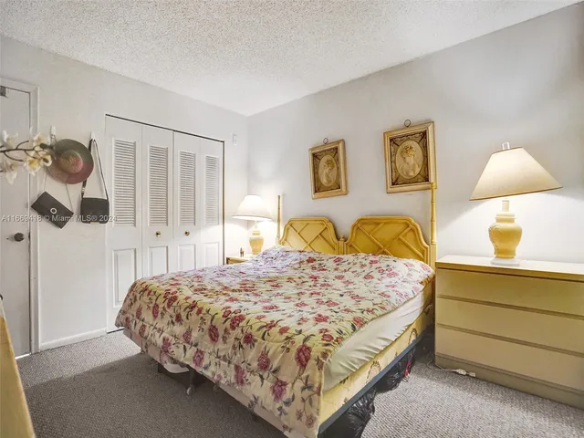 a bedroom with a bed and dresser