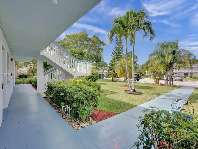 a view of a garden with a house