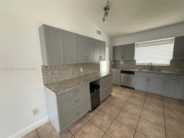 a kitchen with stainless steel appliances granite countertop a sink and cabinets