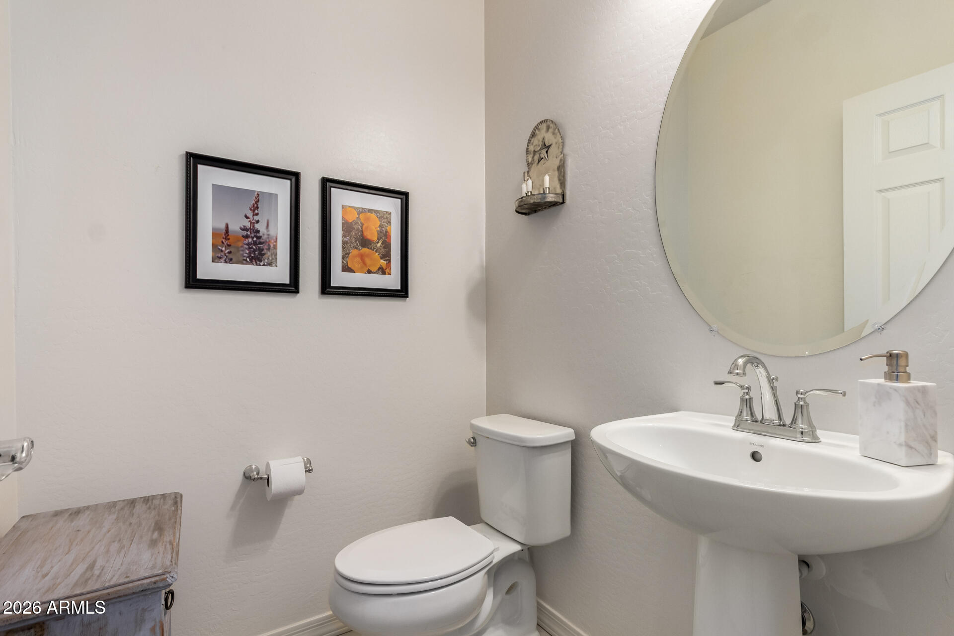 5740 West Raymond Street Phoenix, AZ 85043 - Photo 11 of 41 a bathroom with a toilet sink and mirror