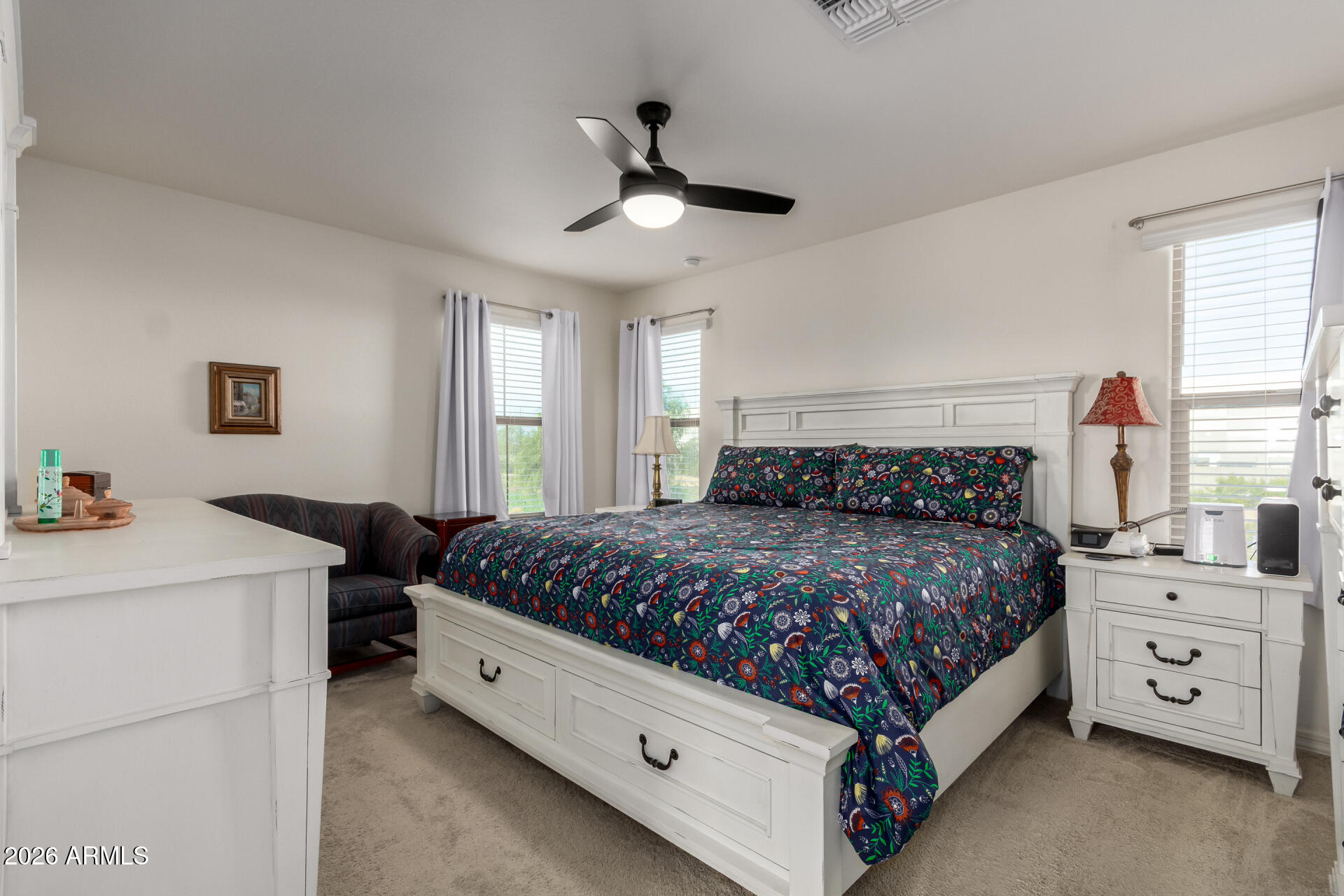 5740 West Raymond Street Phoenix, AZ 85043 - Photo 12 of 41 a bedroom with a bed and a chandelier