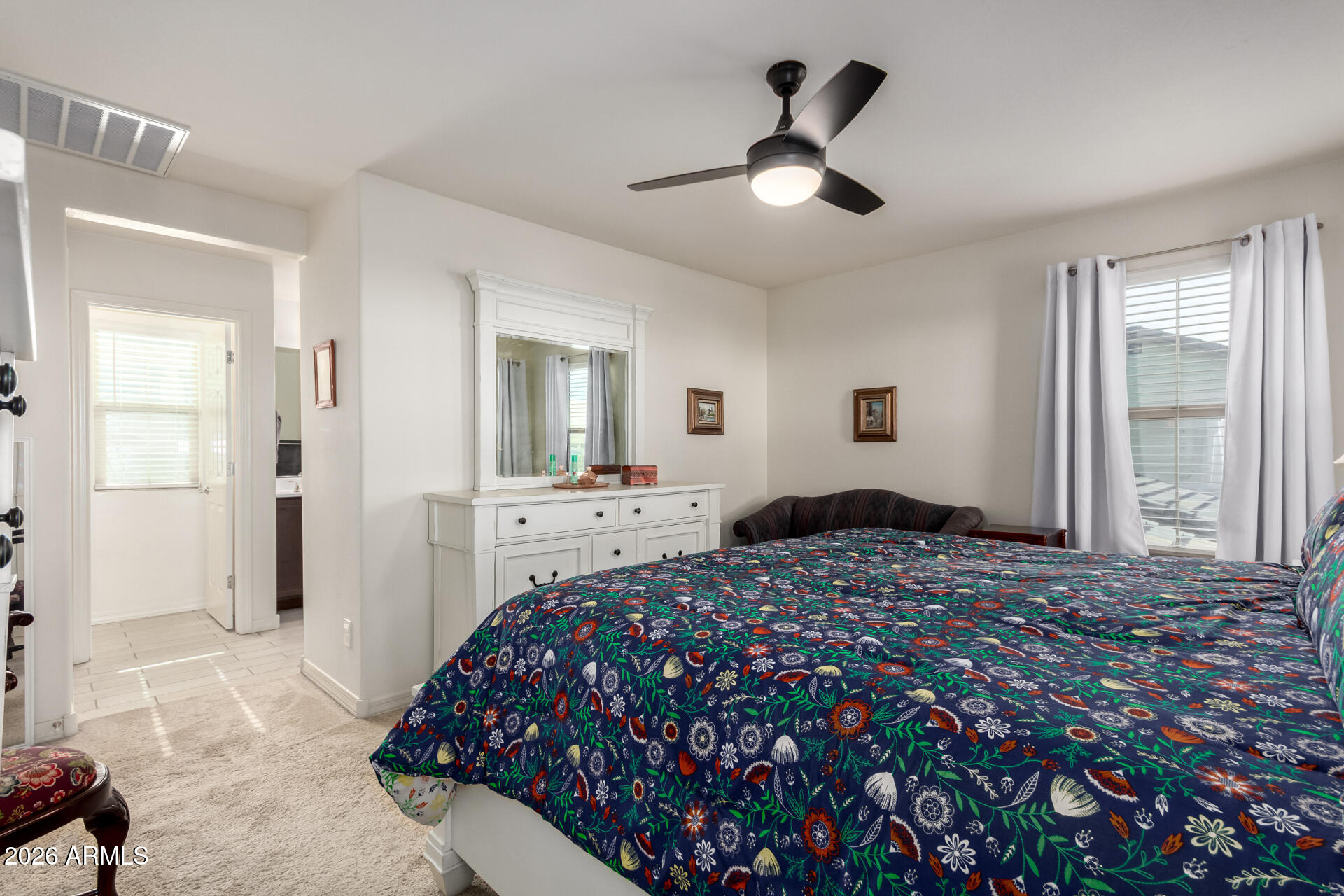 5740 West Raymond Street Phoenix, AZ 85043 - Photo 13 of 41 a bedroom with a bed and a chandelier