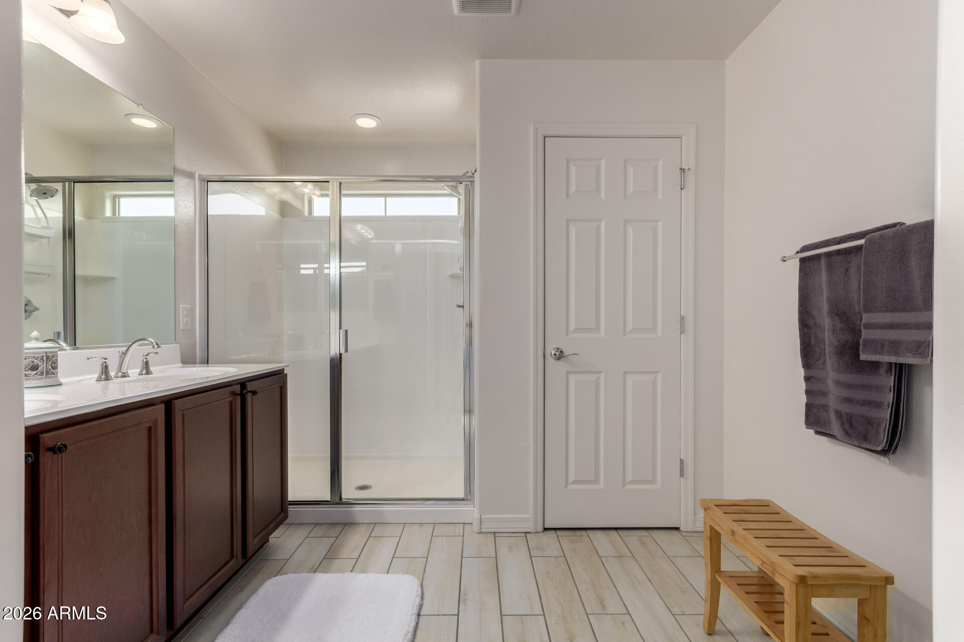 5740 West Raymond Street Phoenix, AZ 85043 - Photo 14 of 41 a bathroom with a glass shower door and a mirror