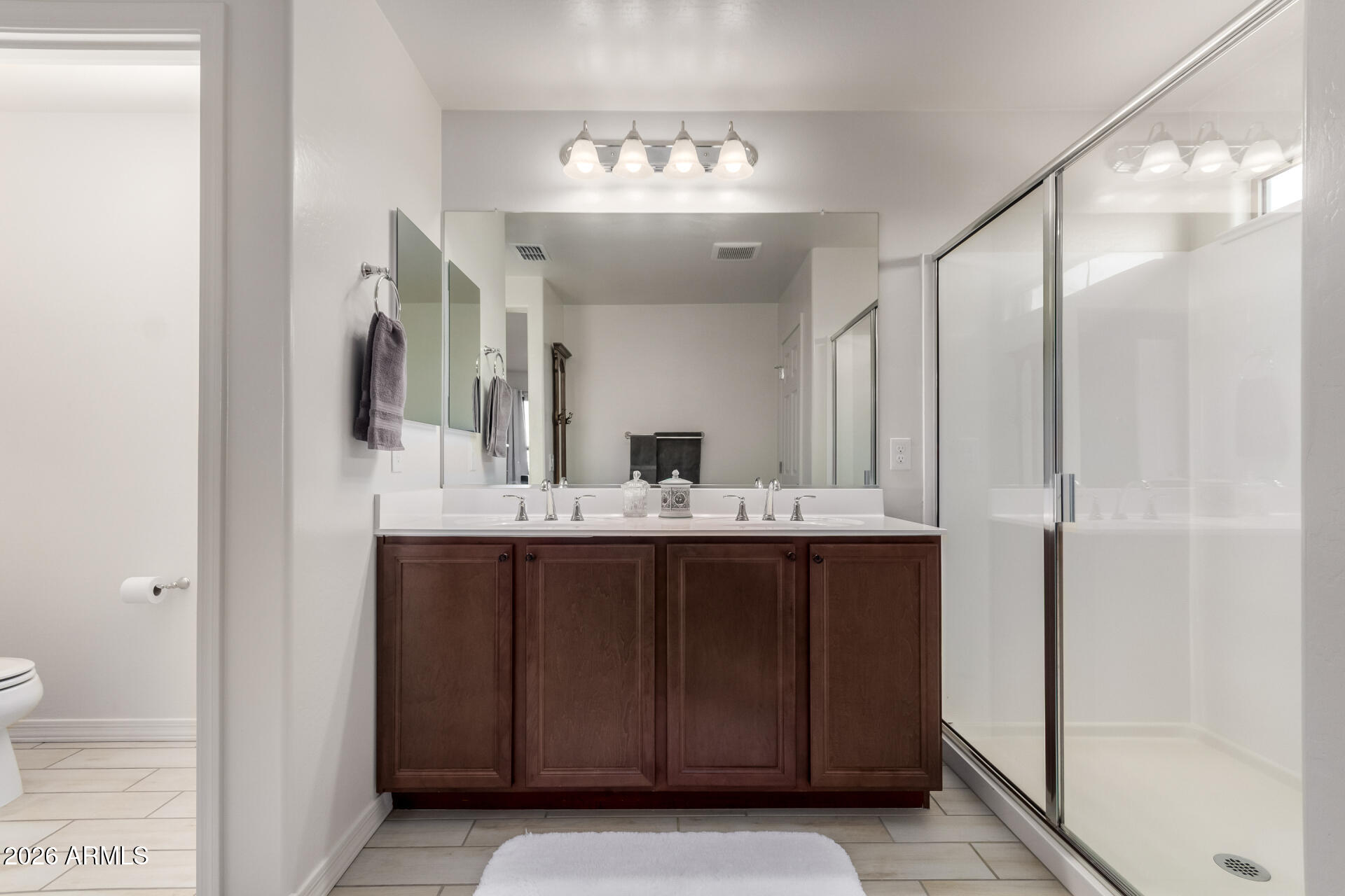 5740 West Raymond Street Phoenix, AZ 85043 - Photo 15 of 41 a bathroom with a double vanity sink and a mirror