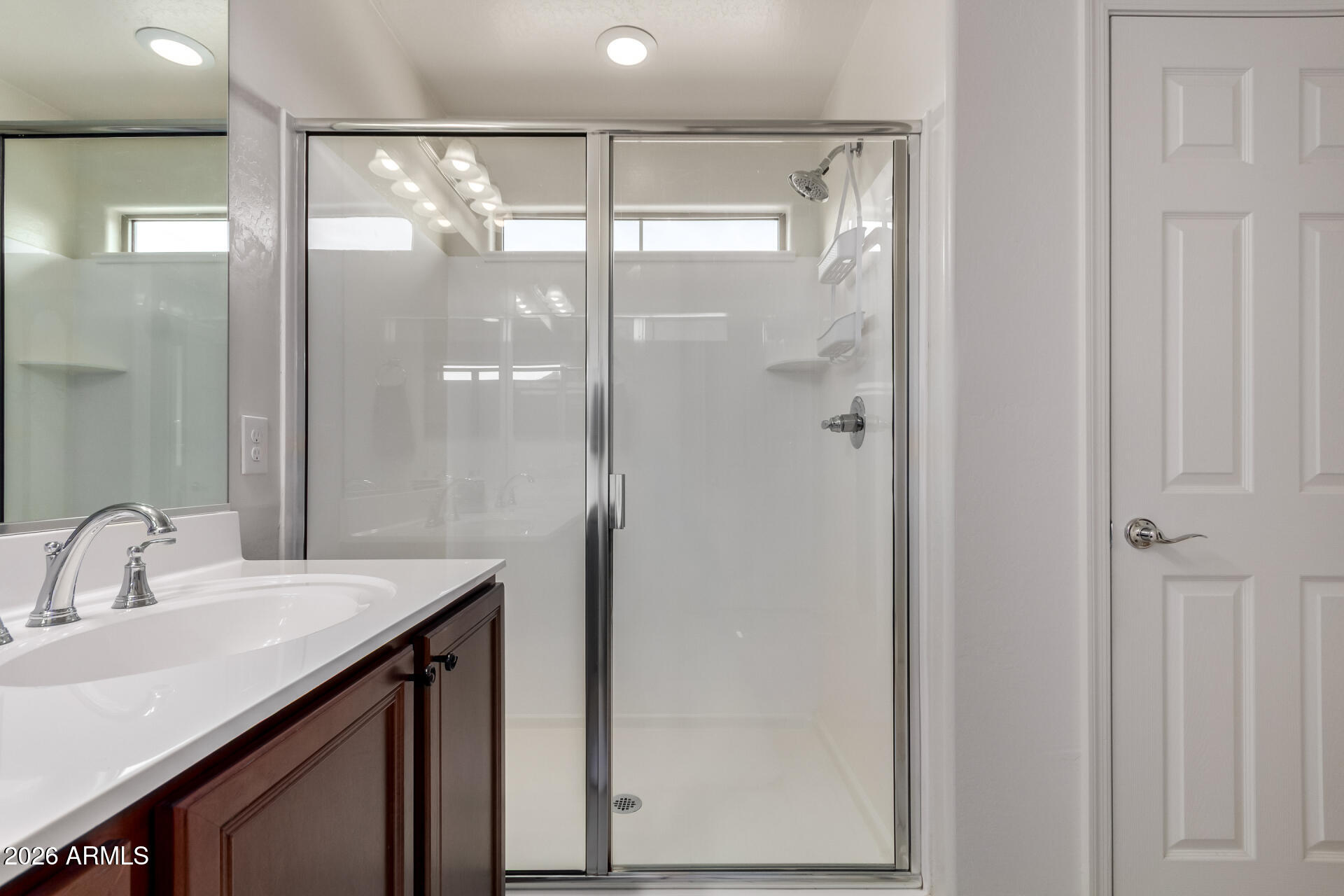 5740 West Raymond Street Phoenix, AZ 85043 - Photo 16 of 41 a bathroom with a shower sink and mirror