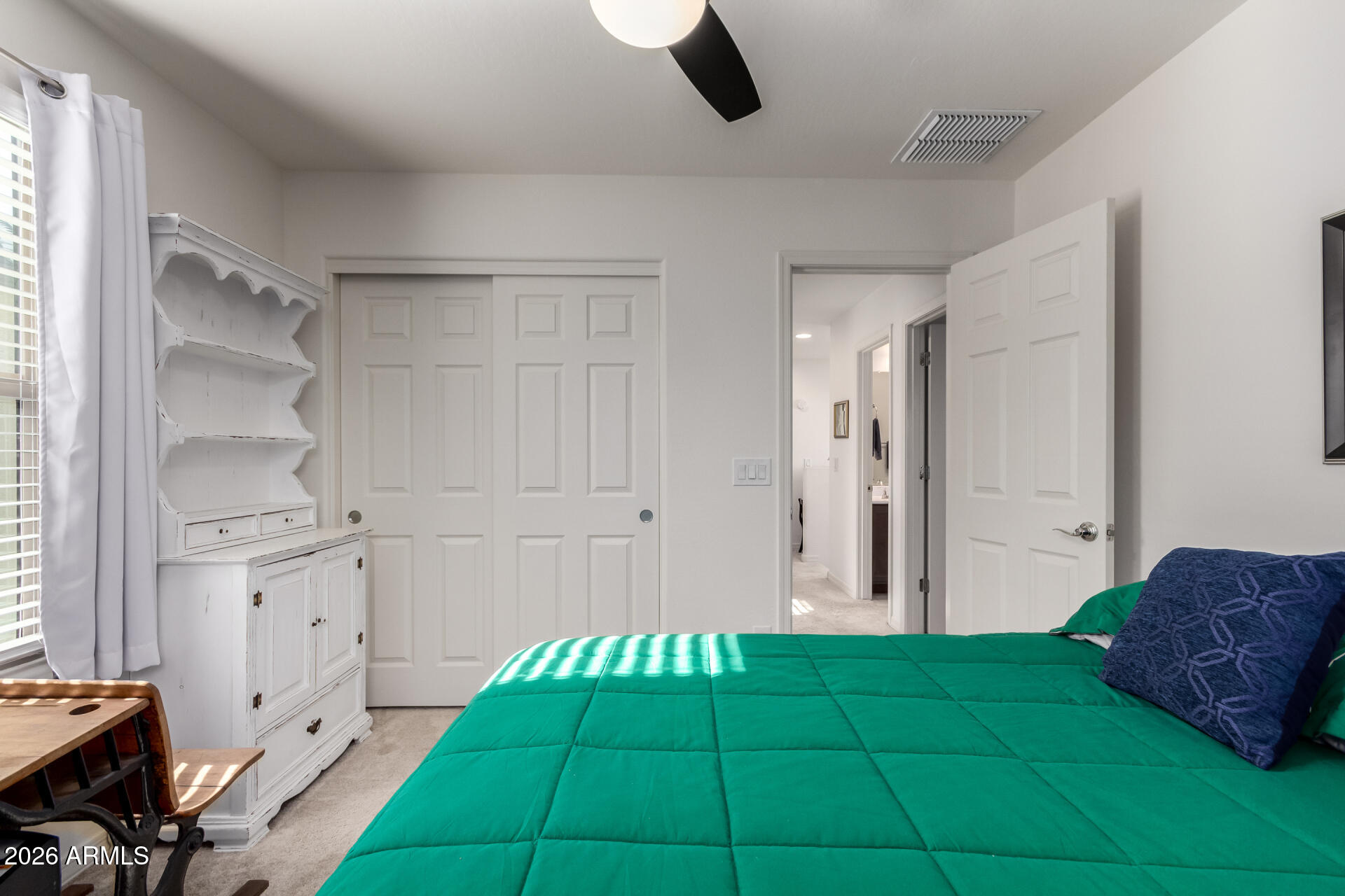 5740 West Raymond Street Phoenix, AZ 85043 - Photo 17 of 41 a bedroom with a bed and a window