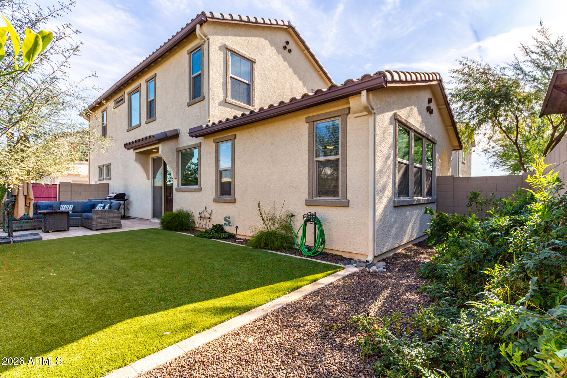 5740 West Raymond Street Phoenix, AZ 85043 - Photo 21 of 41 a front view of a house with a garden