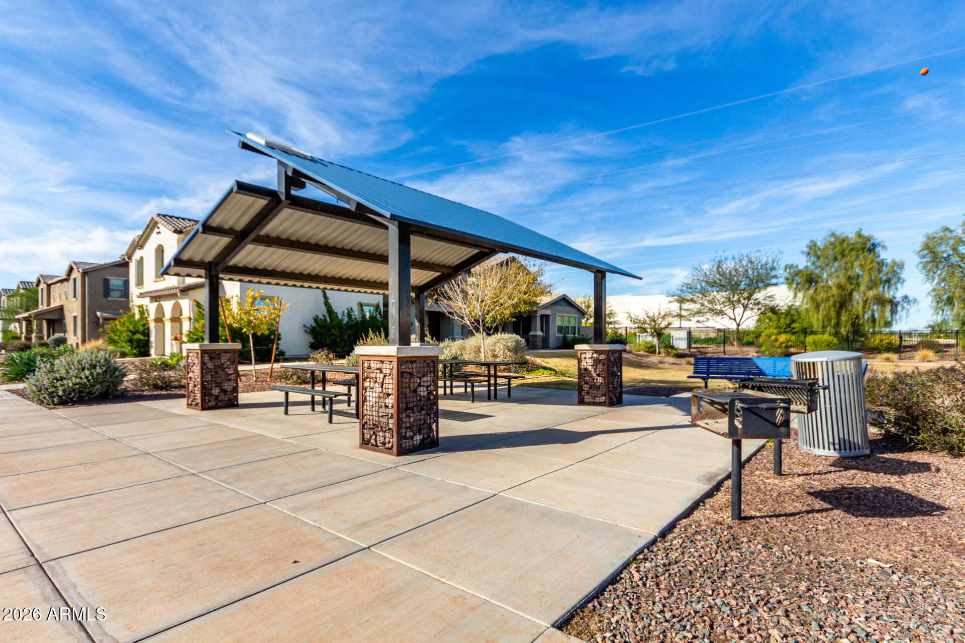 5740 West Raymond Street Phoenix, AZ 85043 - Photo 38 of 41 a view of a patio with a dining table and chairs under an umbrella with a patio