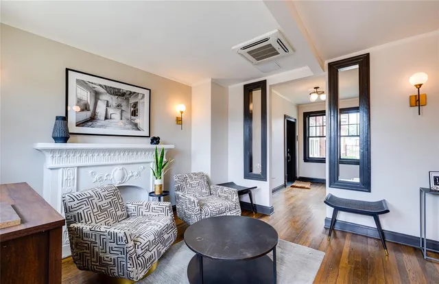 a living room with furniture and a fireplace