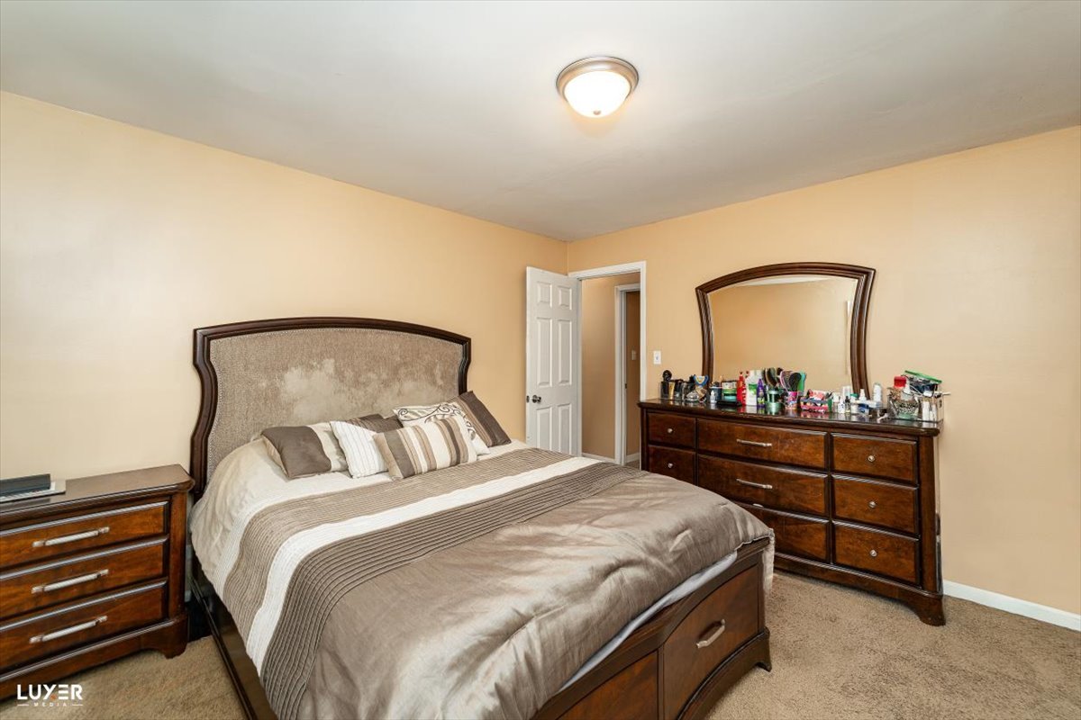 4448 Adele Lane Oak Forest, IL 60452 - Photo 17 of 28 a bedroom with a bed and a mirror