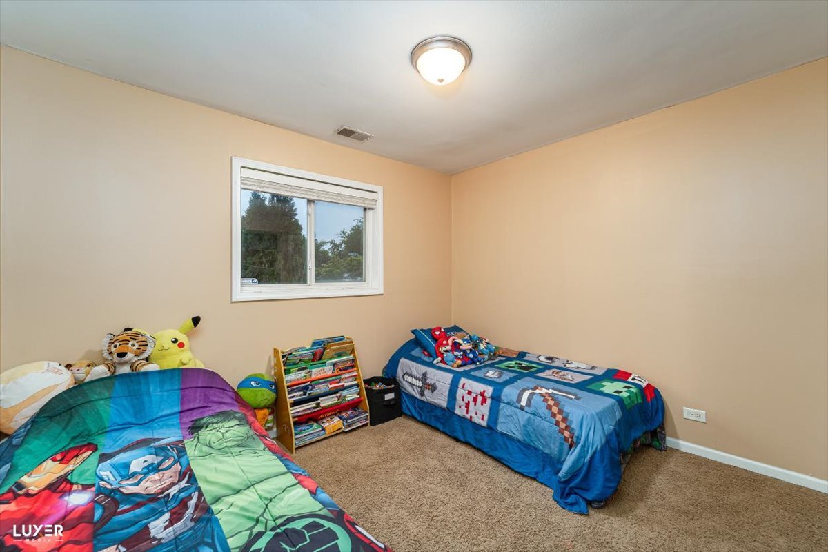 4448 Adele Lane Oak Forest, IL 60452 - Photo 18 of 28 a bedroom with bed and a window