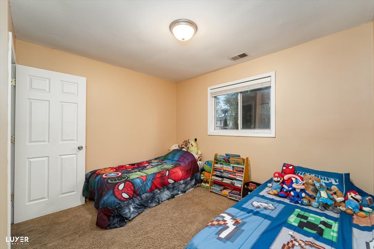 4448 Adele Lane Oak Forest, IL 60452 - Photo 19 of 28 a bedroom with a bed and a window