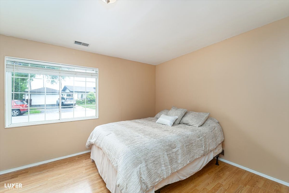 4448 Adele Lane Oak Forest, IL 60452 - Photo 20 of 28 a bedroom with a bed and window