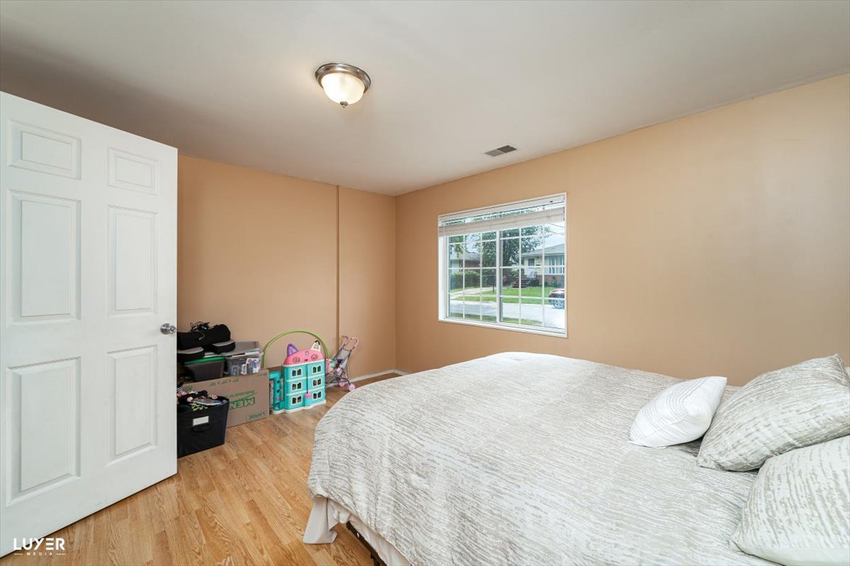 4448 Adele Lane Oak Forest, IL 60452 - Photo 21 of 28 a bedroom with a bed and a window