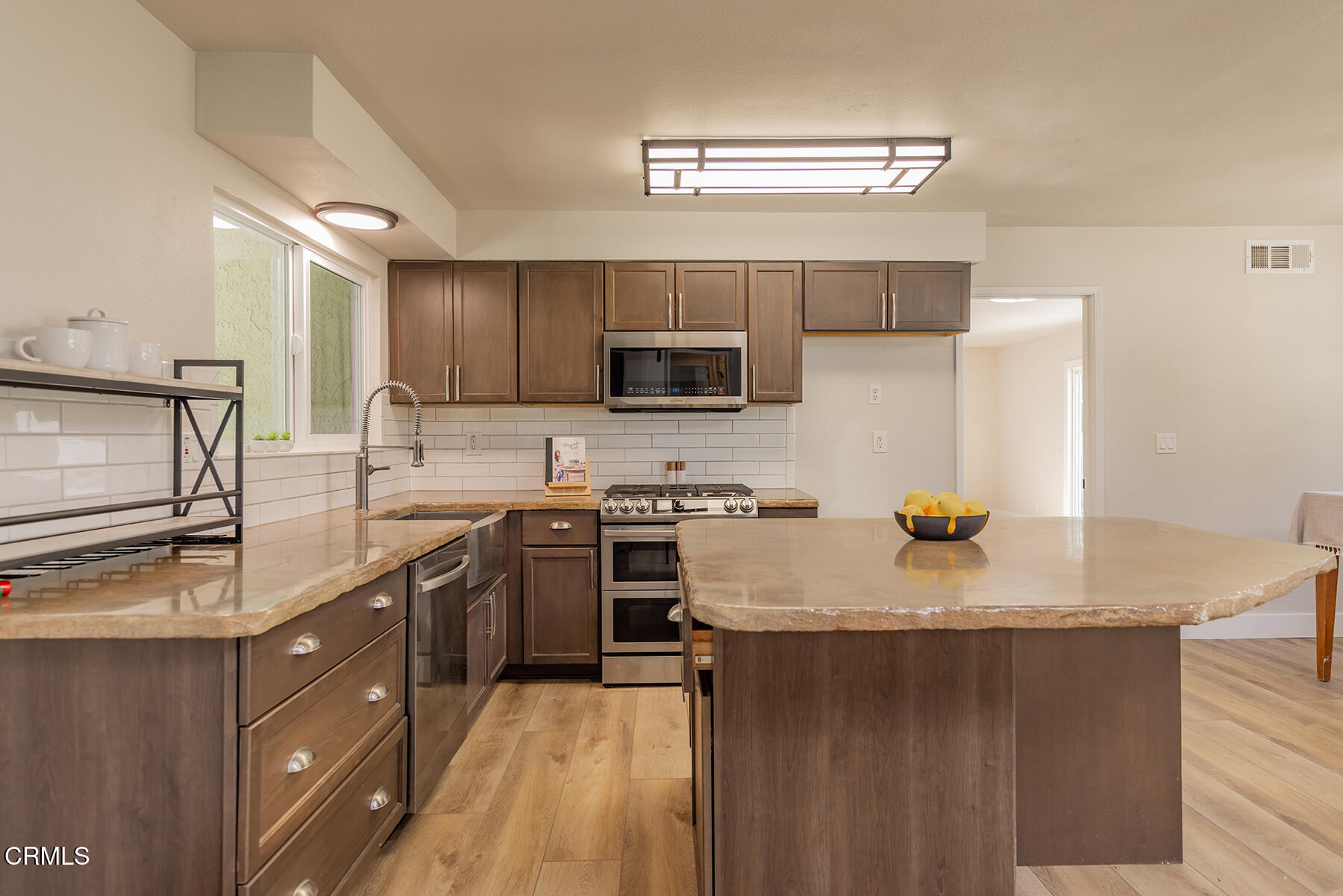 165 Burnham Road Oak View, CA 93022 - Photo 11 of 58 a kitchen with stainless steel appliances a stove sink microwave and cabinets