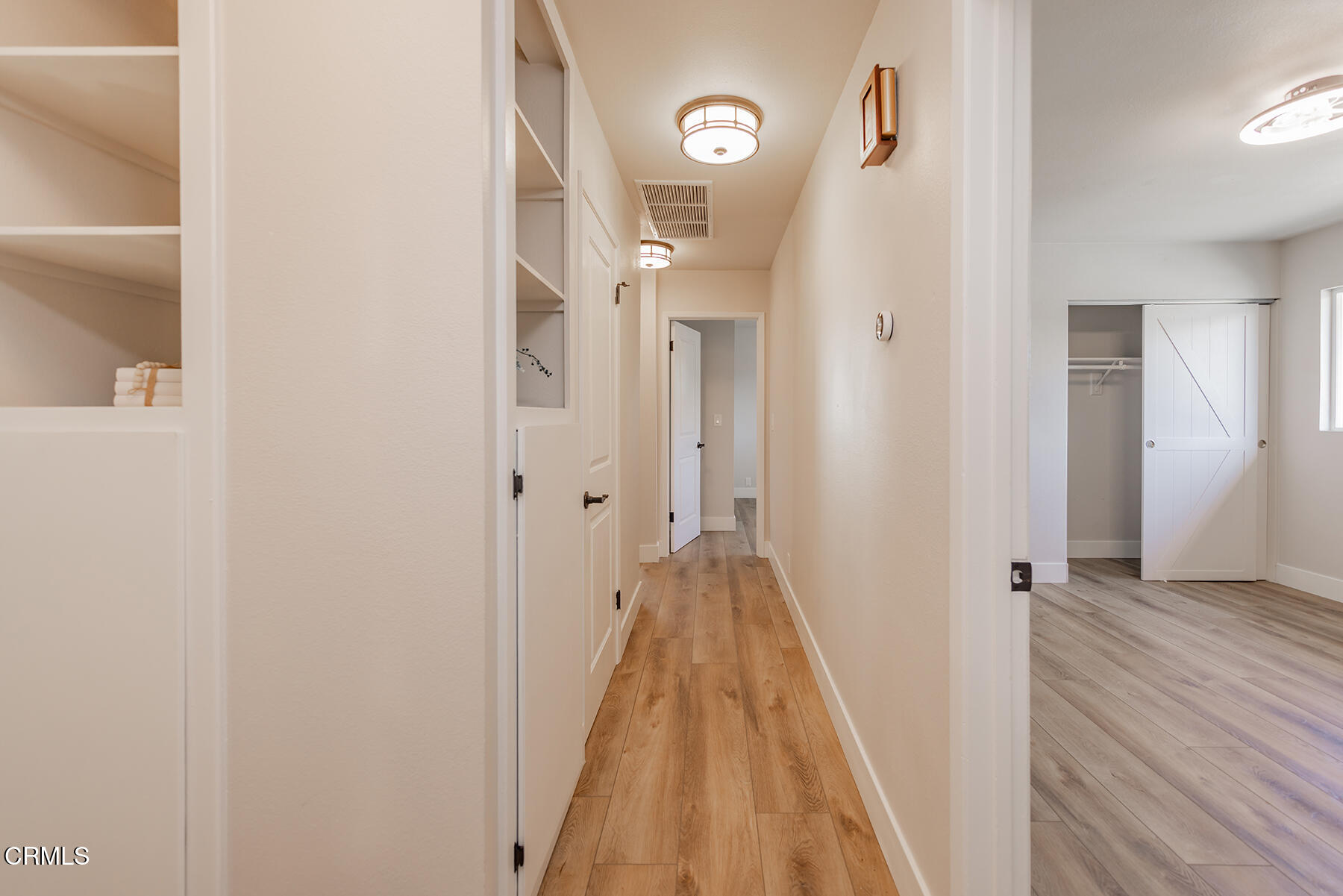 165 Burnham Road Oak View, CA 93022 - Photo 35 of 58 a view of a hallway with wooden floor and a bathroom