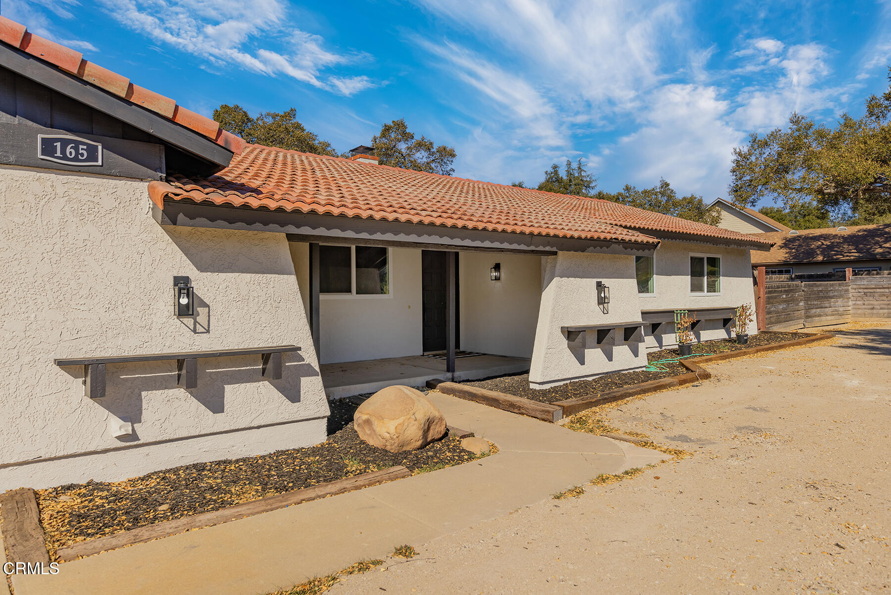 165 Burnham Road Oak View, CA 93022 - Photo 5 of 58 a view of a white house with wooden fence