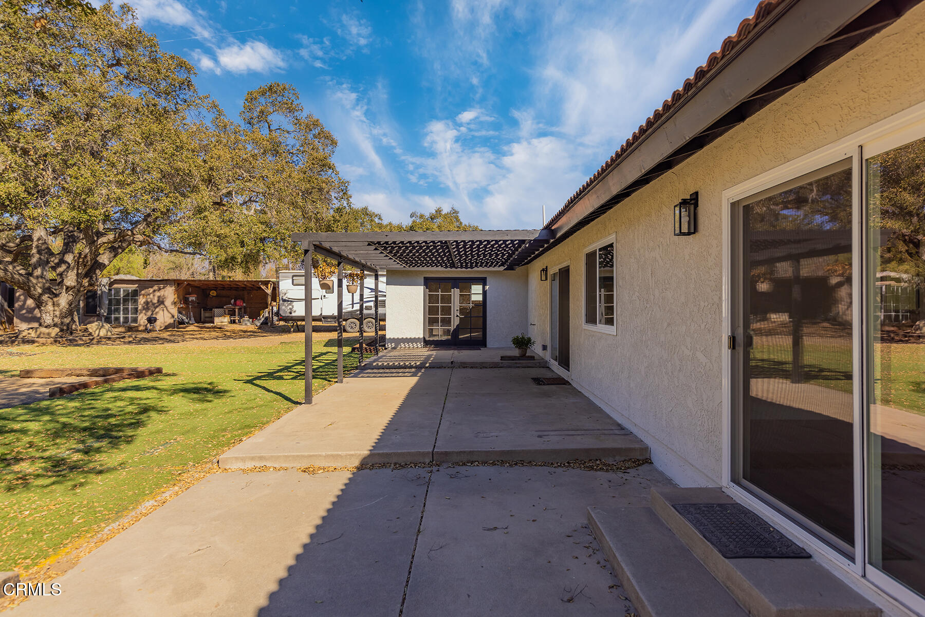165 Burnham Road Oak View, CA 93022 - Photo 8 of 58 a view of a house with many windows and a tree