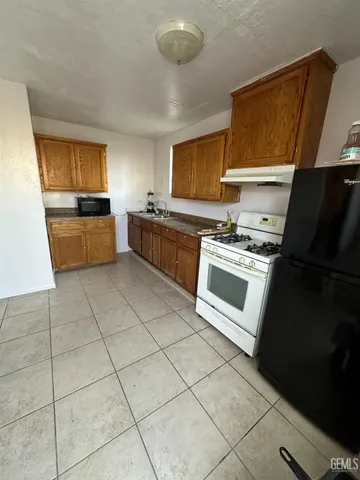 a kitchen with stainless steel appliances a stove a sink and a refrigerator