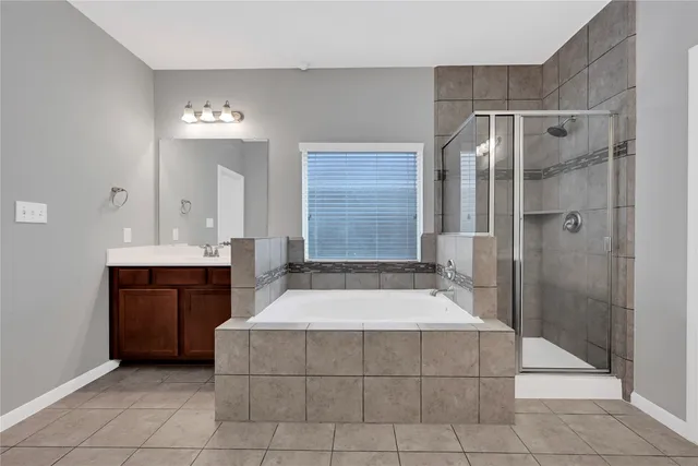 a spacious bathroom with a bathtub shower and sink