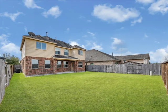 a view of a house with a big yard next to a yard