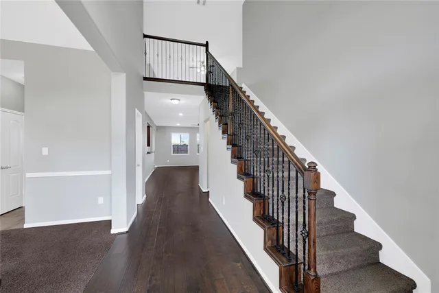 a view of a hallway with wooden floor and entryway