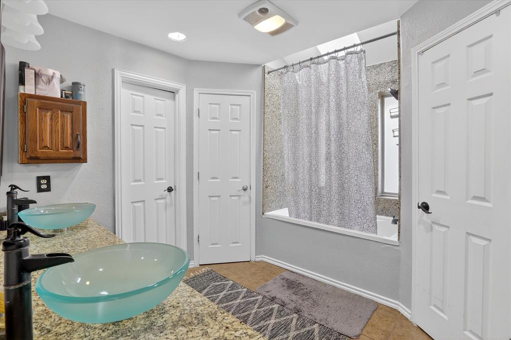 2010 Libby Lane Grand Prairie, TX 75050 - Photo 17 of 24 a bathroom with a sink toilet and shower