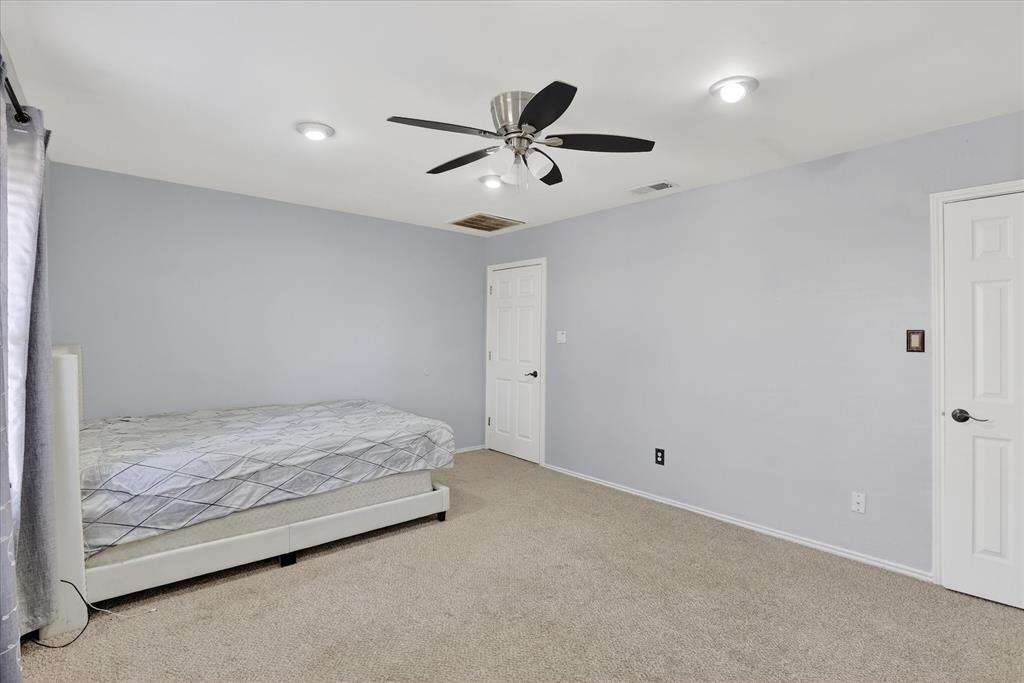 2010 Libby Lane Grand Prairie, TX 75050 - Photo 20 of 24 a bedroom with a bed and a ceiling fan