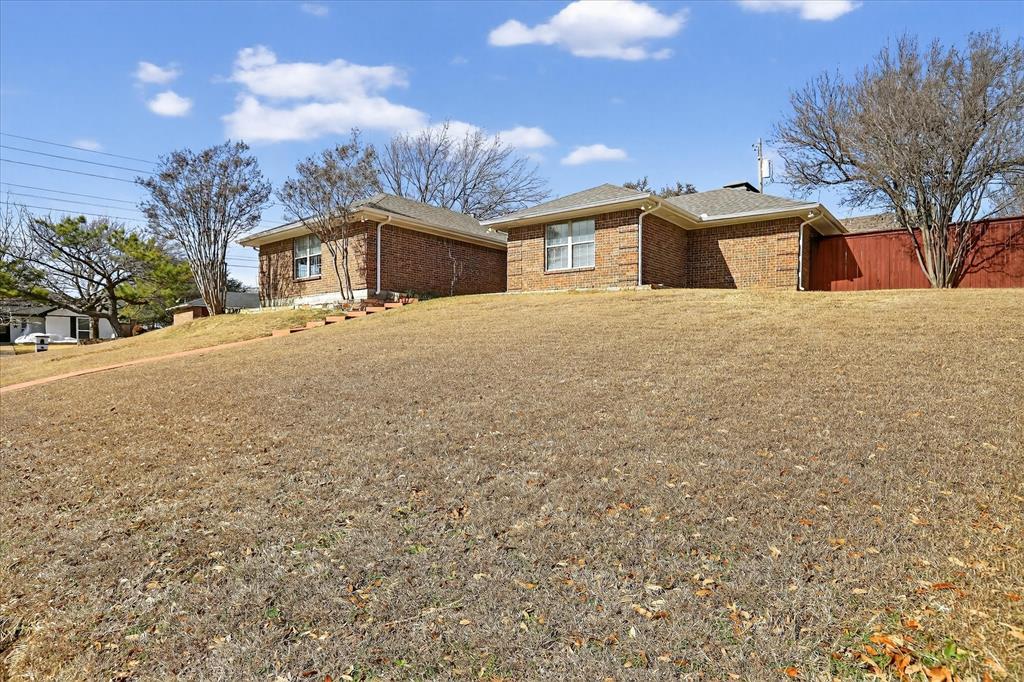 2010 Libby Lane Grand Prairie, TX 75050 - Photo 2 of 24 a front view of a house with a yard and a garage
