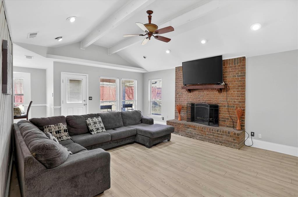2010 Libby Lane Grand Prairie, TX 75050 - Photo 8 of 24 a living room with furniture a fireplace and a flat screen tv