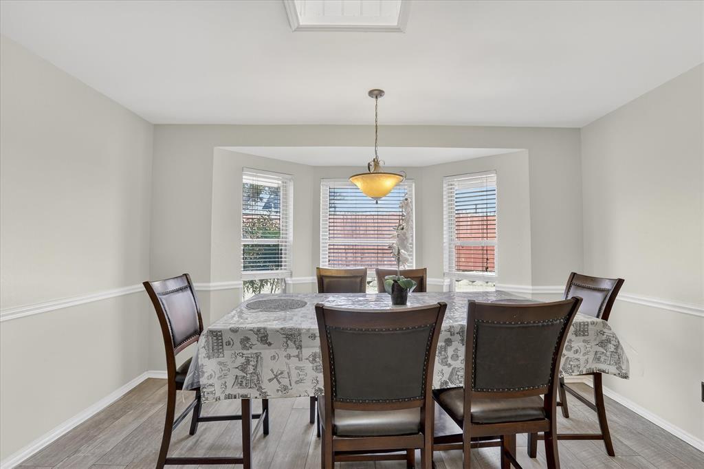 2010 Libby Lane Grand Prairie, TX 75050 - Photo 10 of 24 a dining room with furniture a chandelier and window