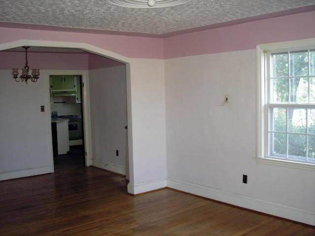 8357 Snow Creek Road Penhook, VA 24137 - Photo 6 of 8 an empty room with wooden floor and windows