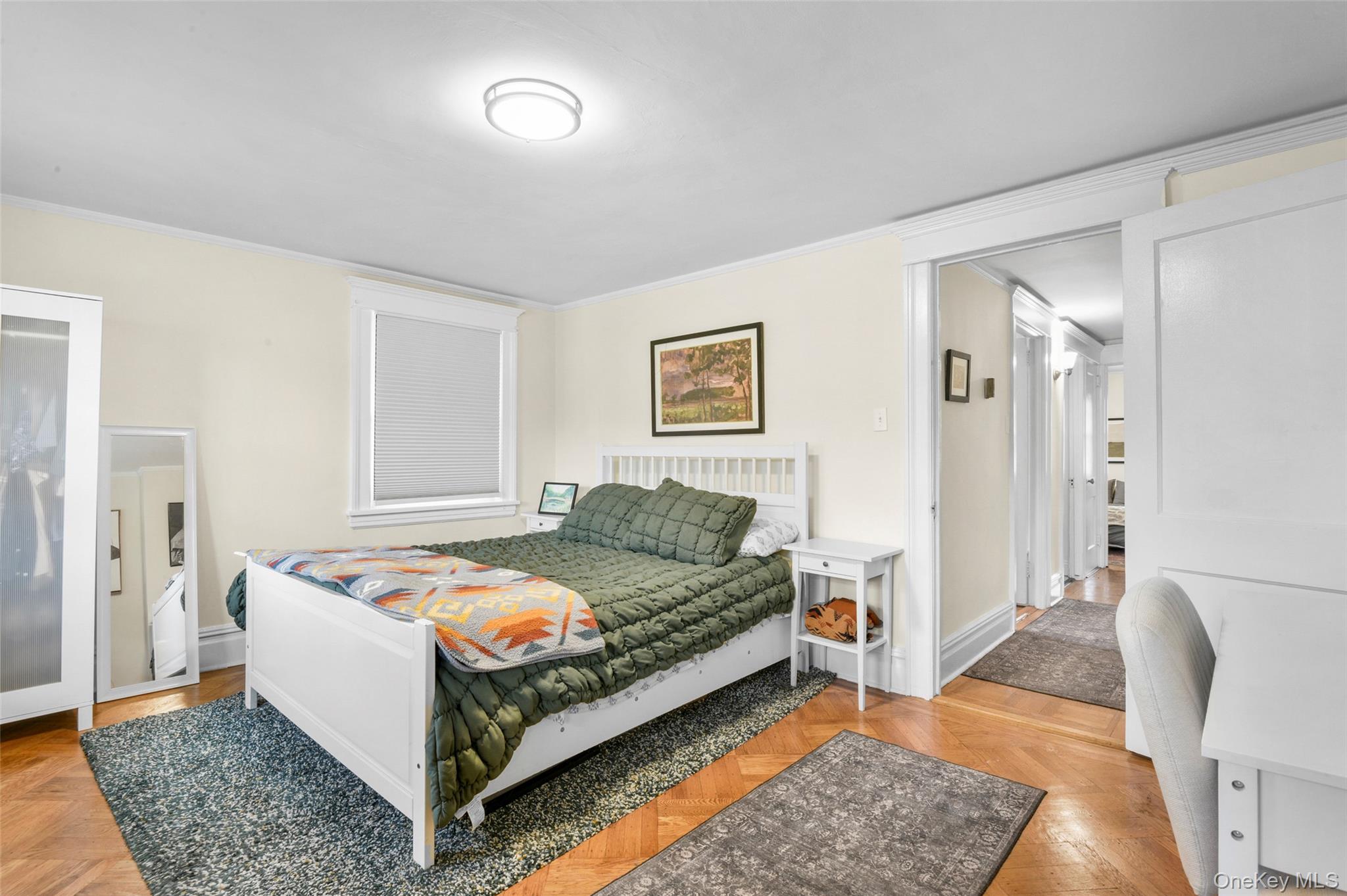 330 First Avenue, Unit LEFT SIDE Pelham, NY 10803 - Photo 12 of 19 a bed room with a bed and a chair