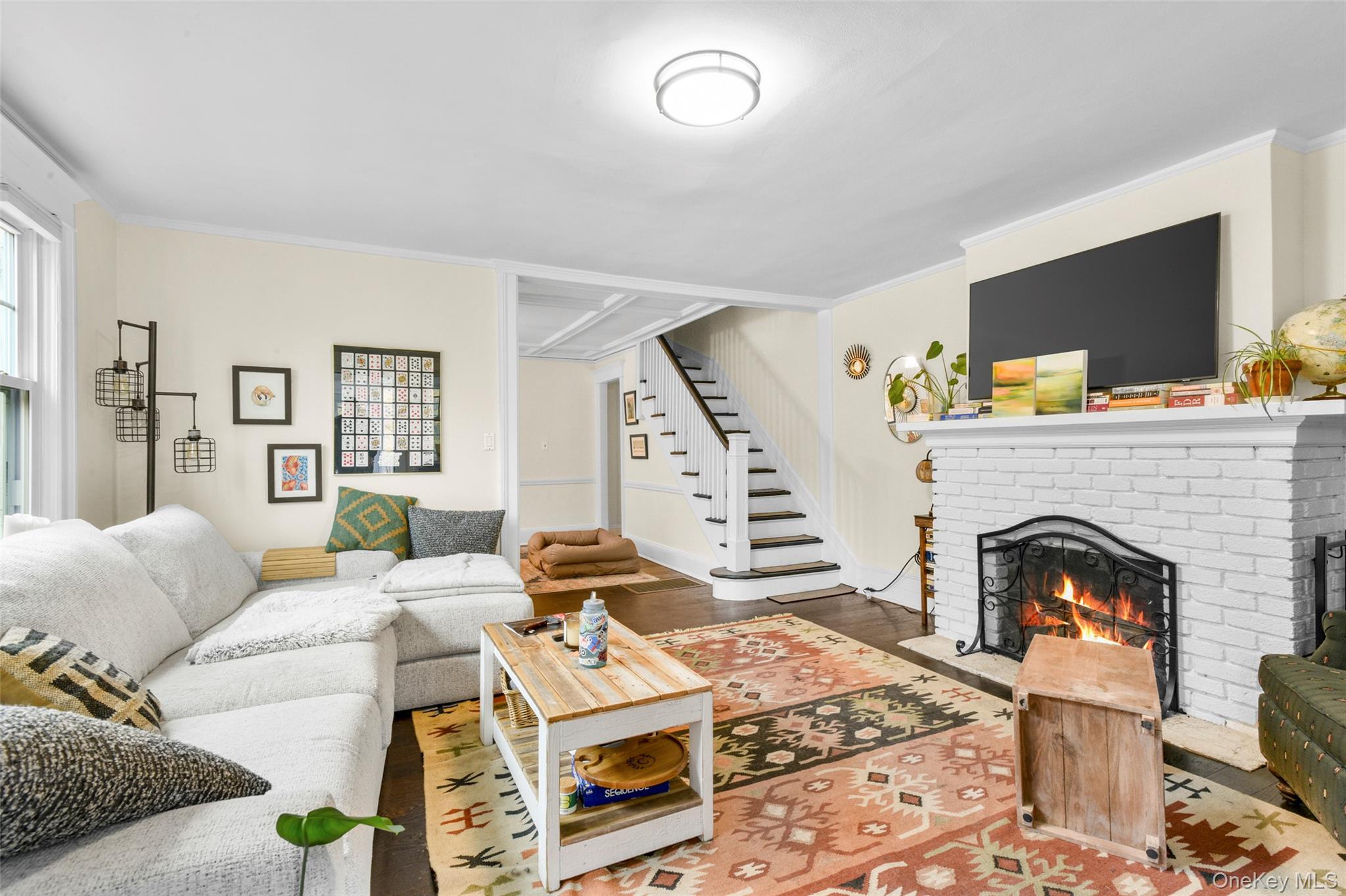 330 First Avenue, Unit LEFT SIDE Pelham, NY 10803 - Photo 3 of 19 a living room with furniture a flat screen tv and a fireplace