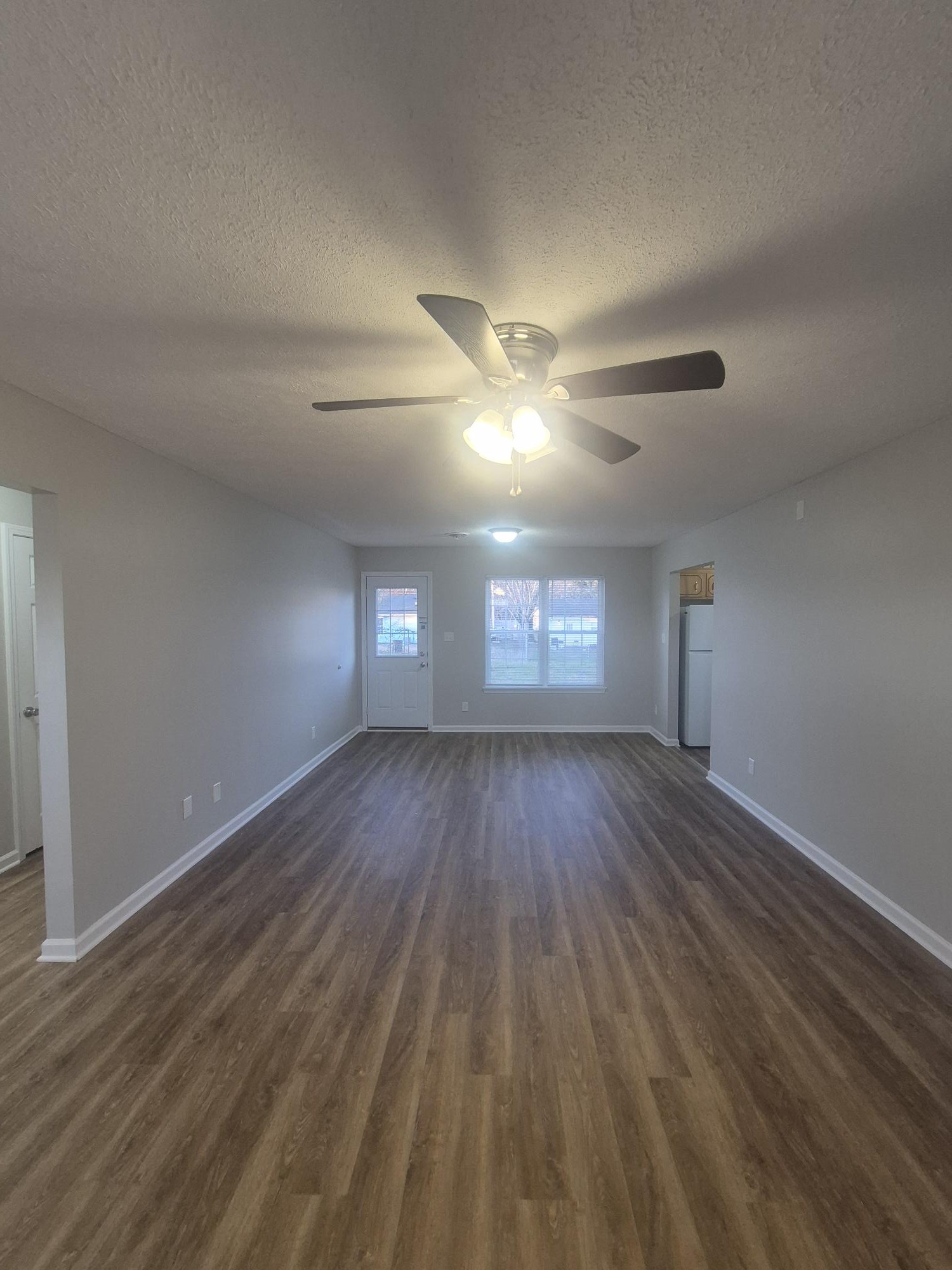 403 Eddy Street Oak Grove, KY 42262 - Photo 4 of 13 a view of empty room with window and wooden floor