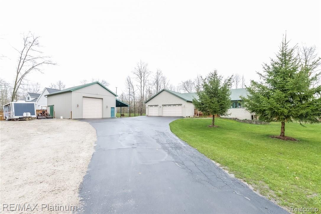 4558 North Latson Road Howell, MI 48855 - Photo 29 of 46 Paved Driveway leads to 3-car garage and barn with add'l gravel parking