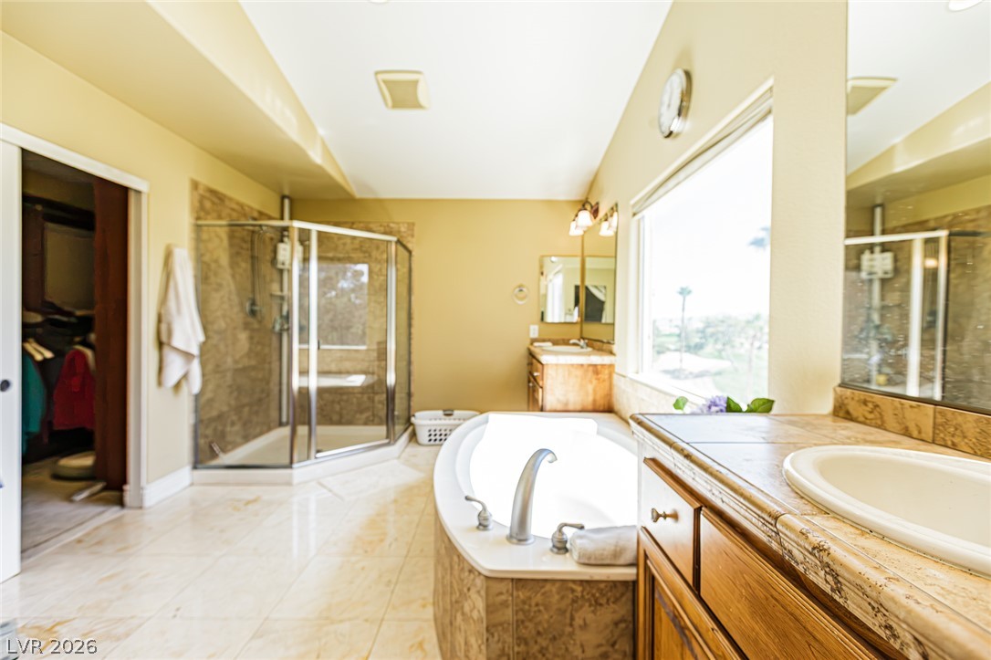 75 Tall Ruff Drive Las Vegas, NV 89148 - Photo 39 of 64 A spacious bathroom features tile flooring, a soaking tub, and a separate glass-enclosed shower.