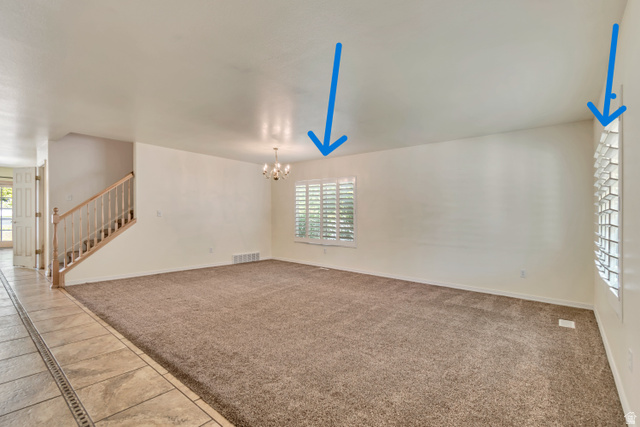 546 Wheatridge Road Tooele, UT 84074 - Photo 8 of 49 Spacious room featuring neutral carpeting, white walls, and multiple windows with white plantation shutters