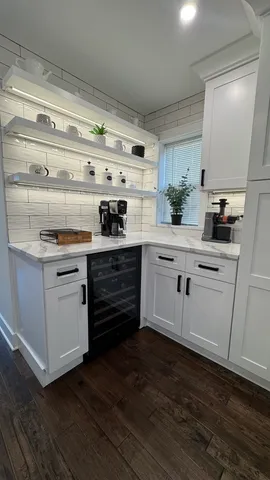 a kitchen with a stove cabinets and wooden floor