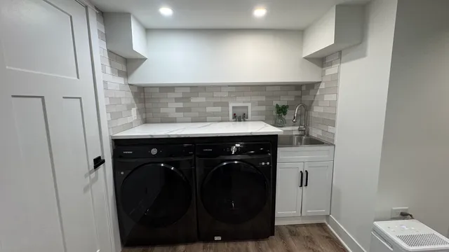 a close view of a utility room with washer and dryer