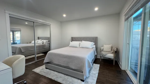 a bedroom with a bed and a chair