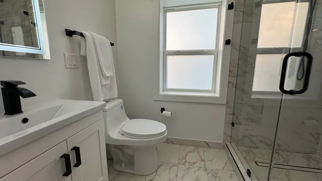 a bathroom with a sink toilet and shower
