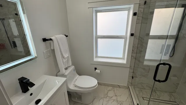 a bathroom with a toilet and a shower