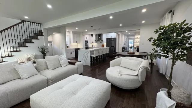 a living room with furniture and a potted plant