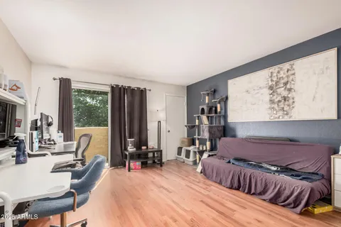 a bedroom with furniture and a large window