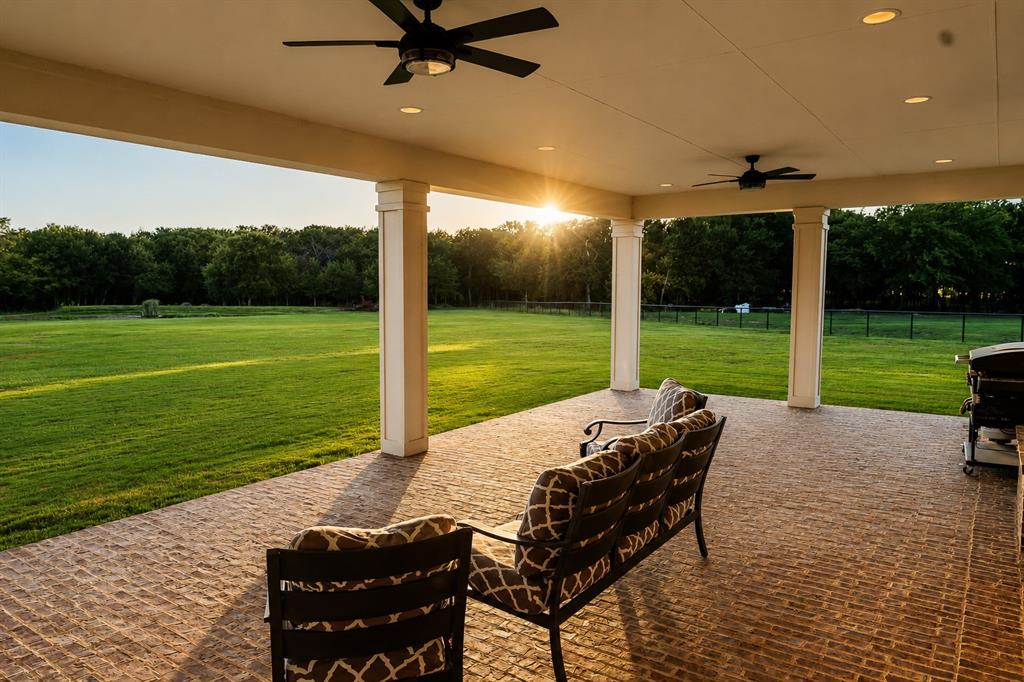 985 Vest Lane Pilot Point, TX 76258 - Photo 26 of 40 Expansive covered patio featuring a stamped concrete surface, recessed lighting, and dual ceiling fans