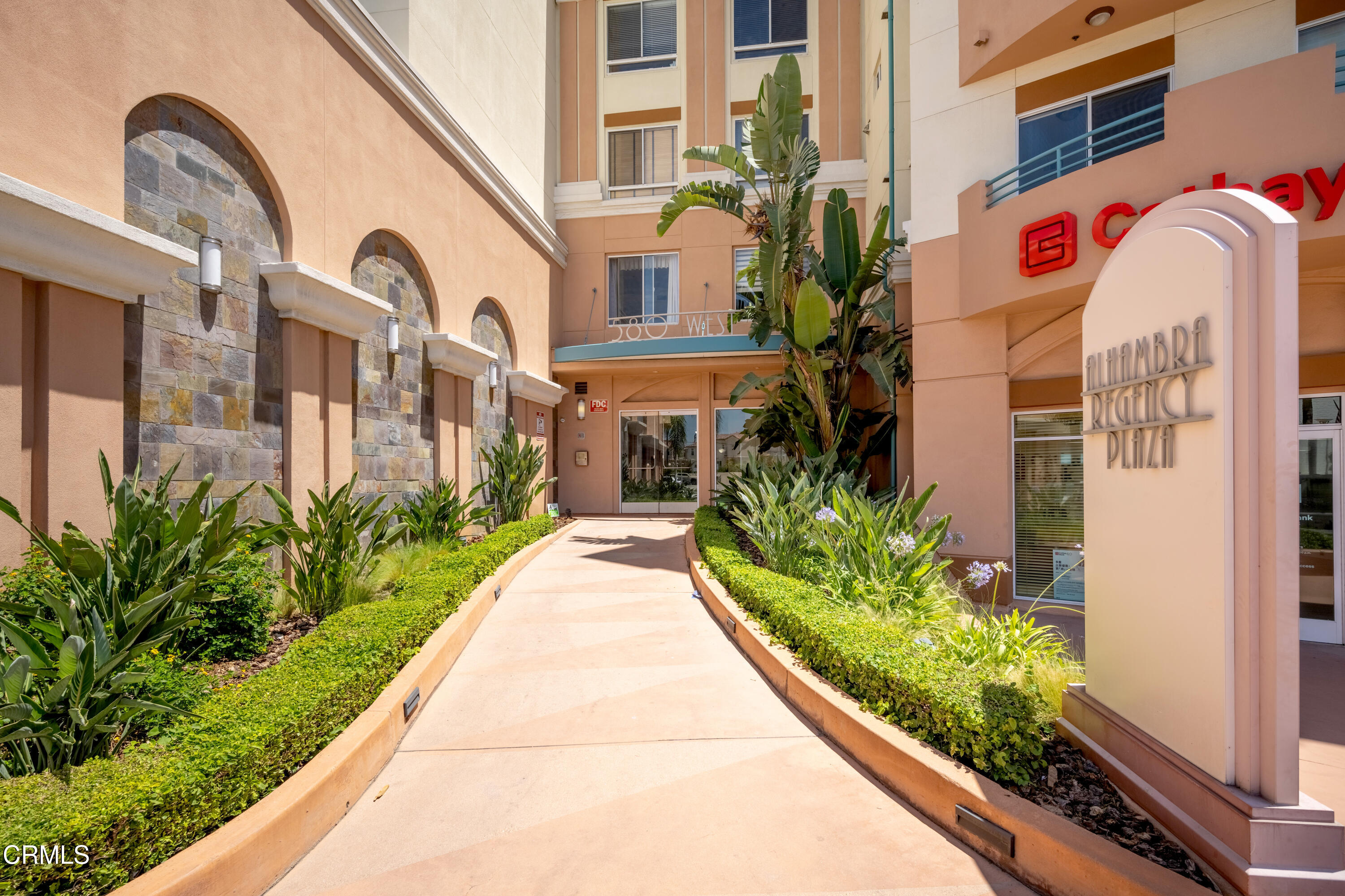 a front view of a multi story building with yard