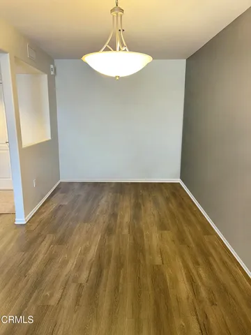 a view of room with wooden floor